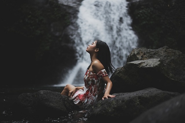 Women in front of a waterfall